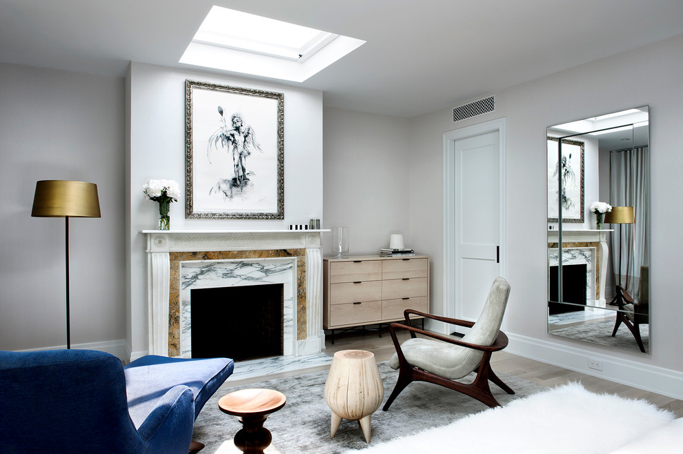 Immagine di un soggiorno chic chiuso con sala formale, pareti grigie, parquet chiaro e camino classico