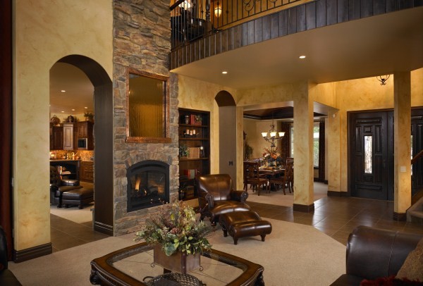 Medium sized traditional formal enclosed living room in Denver with beige walls, carpet, a two-sided fireplace, a stone fireplace surround, no tv and beige floors.