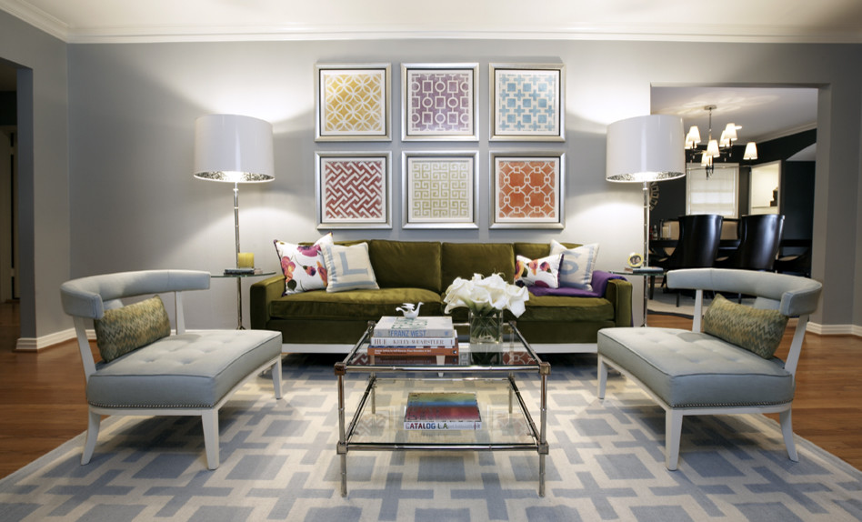 Trendy medium tone wood floor living room photo in Dallas with gray walls, a standard fireplace and a wall-mounted tv