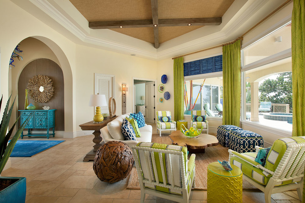 Imagen de salón abierto tropical con paredes beige, suelo de travertino y suelo beige