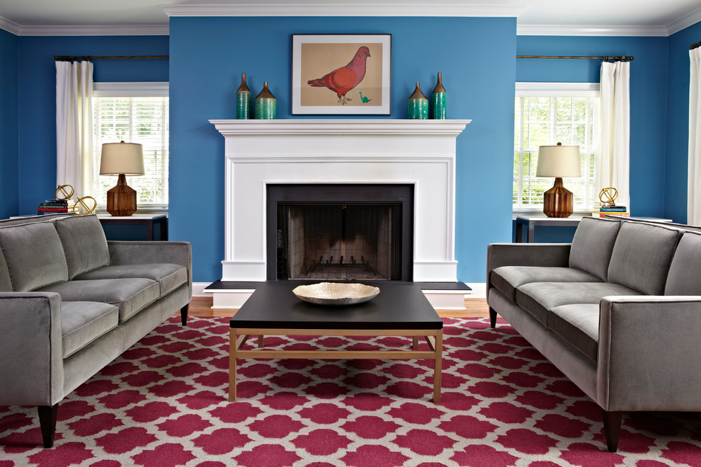 This is an example of a traditional formal living room in New York with blue walls and a standard fireplace.