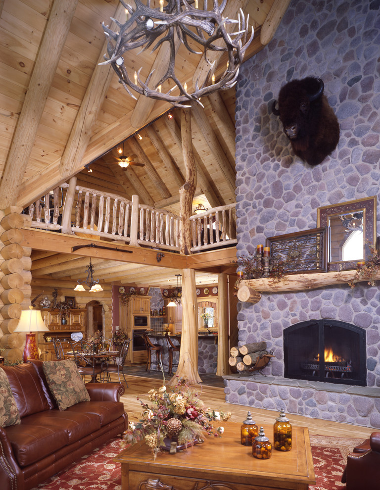 Mountain style living room photo in Cleveland with a standard fireplace, a stone fireplace and no tv