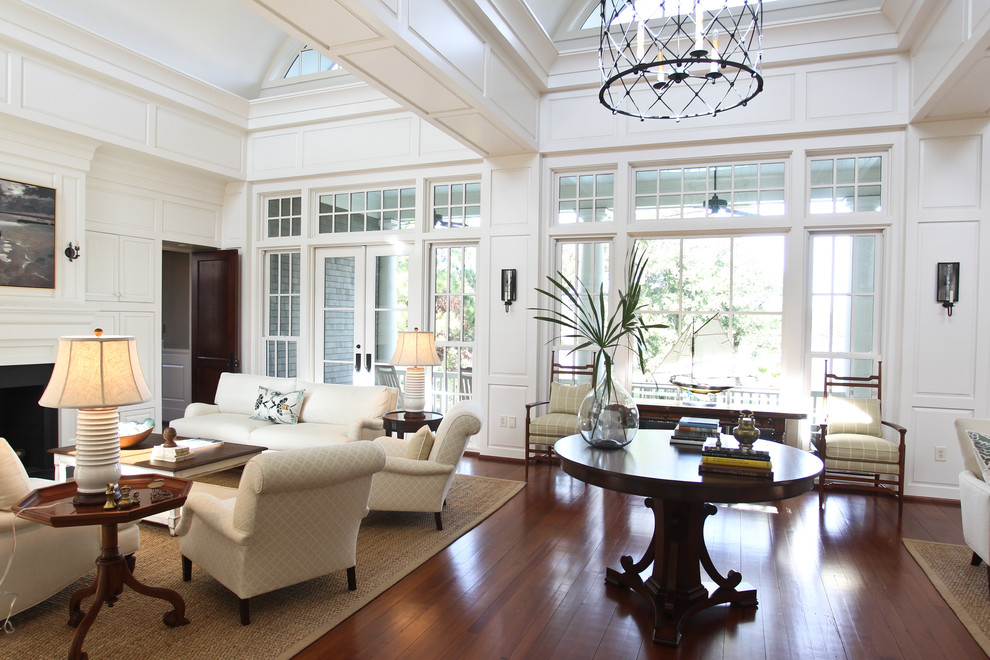Example of a huge eclectic living room design in Charleston with white walls