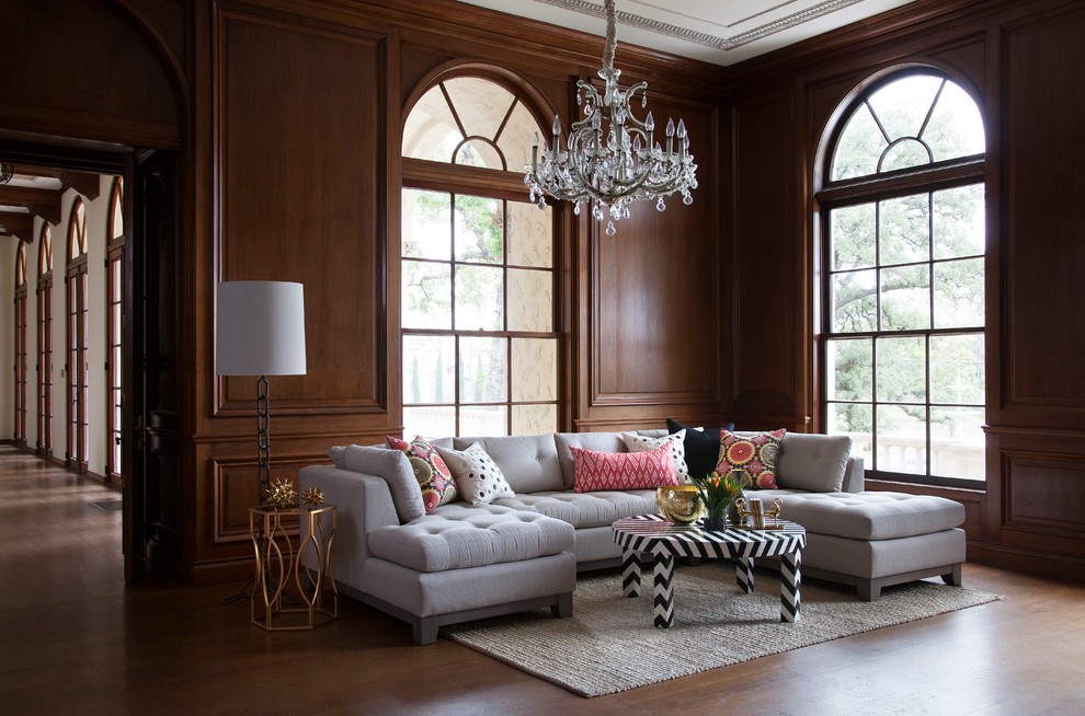 Mediterranean formal living room in Austin with dark hardwood flooring.