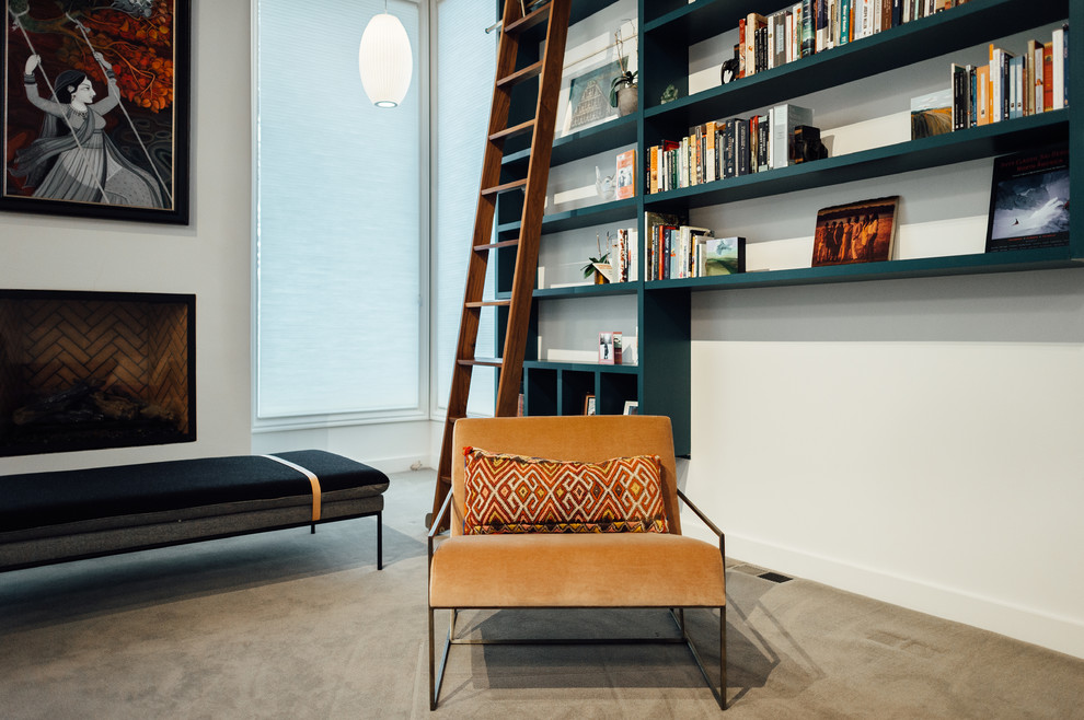 Inspiration for a mid-sized mid-century modern loft-style carpeted and beige floor living room library remodel in Salt Lake City with white walls, a standard fireplace and a plaster fireplace