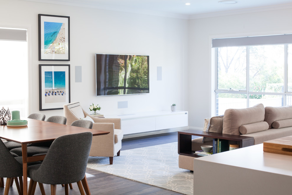 This is an example of a large contemporary open plan living room in Sydney with white walls, porcelain flooring, a wall mounted tv and brown floors.