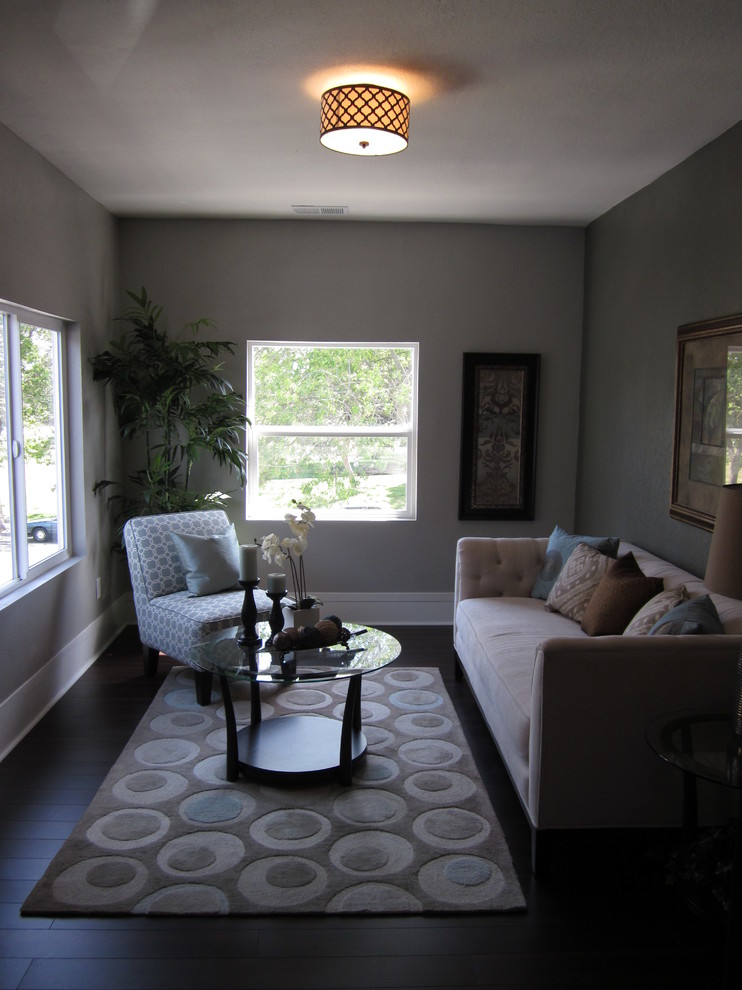 This is an example of a small contemporary formal enclosed living room in San Francisco with grey walls, dark hardwood flooring, no fireplace and no tv.