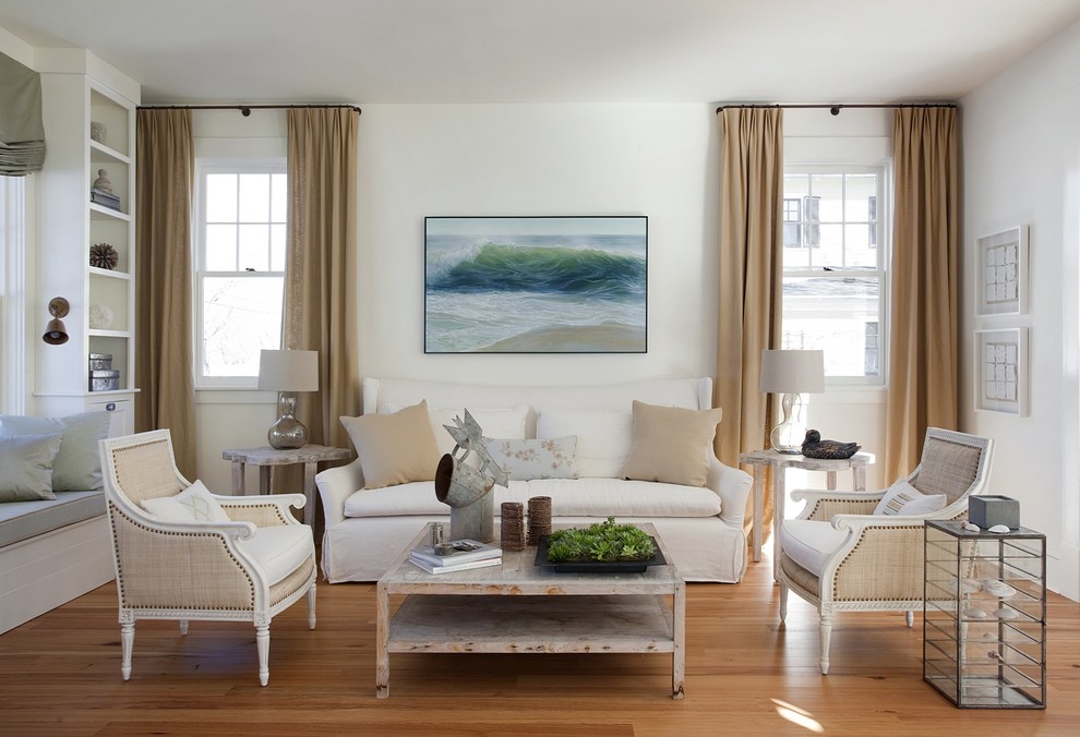This is an example of a beach style enclosed living room in Boston with white walls.