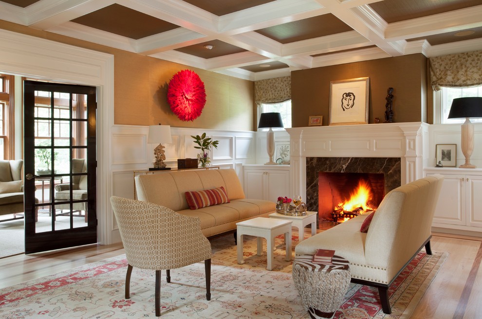 На фото: гостиная комната среднего размера в стиле неоклассика (современная классика) с коричневыми стенами и стандартным камином