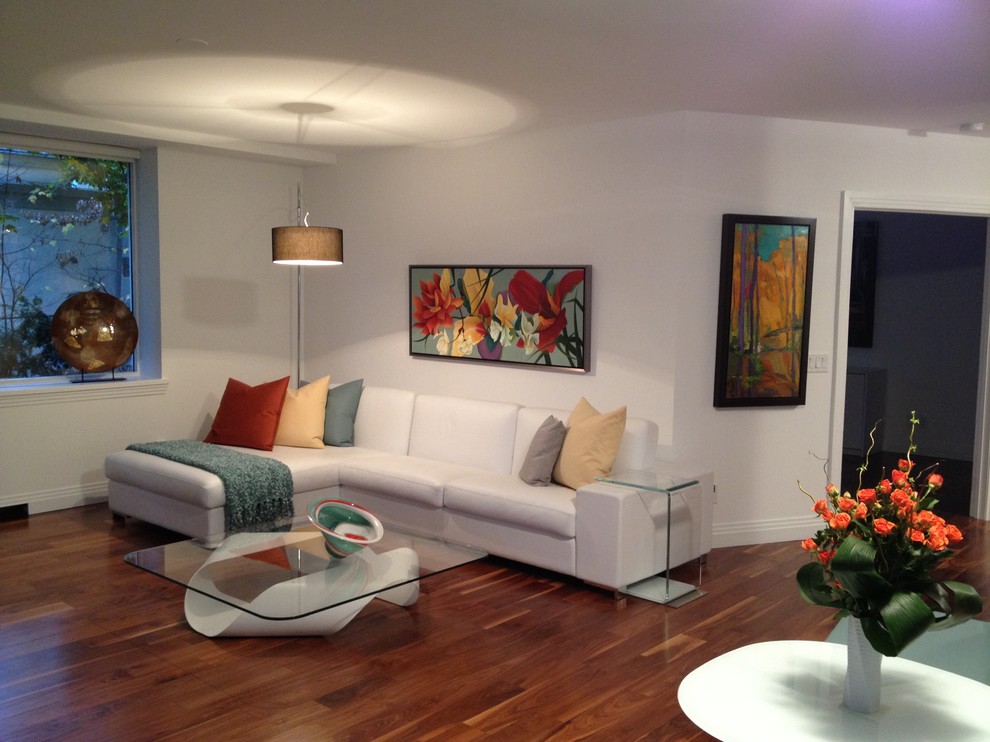Example of a small minimalist open concept medium tone wood floor living room design in Toronto with white walls, no fireplace and no tv