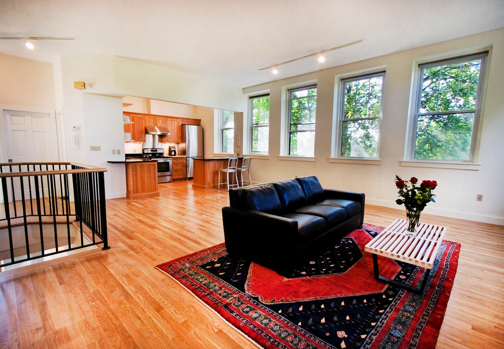 Foto di un soggiorno minimal di medie dimensioni e aperto con pavimento in legno massello medio e pareti beige