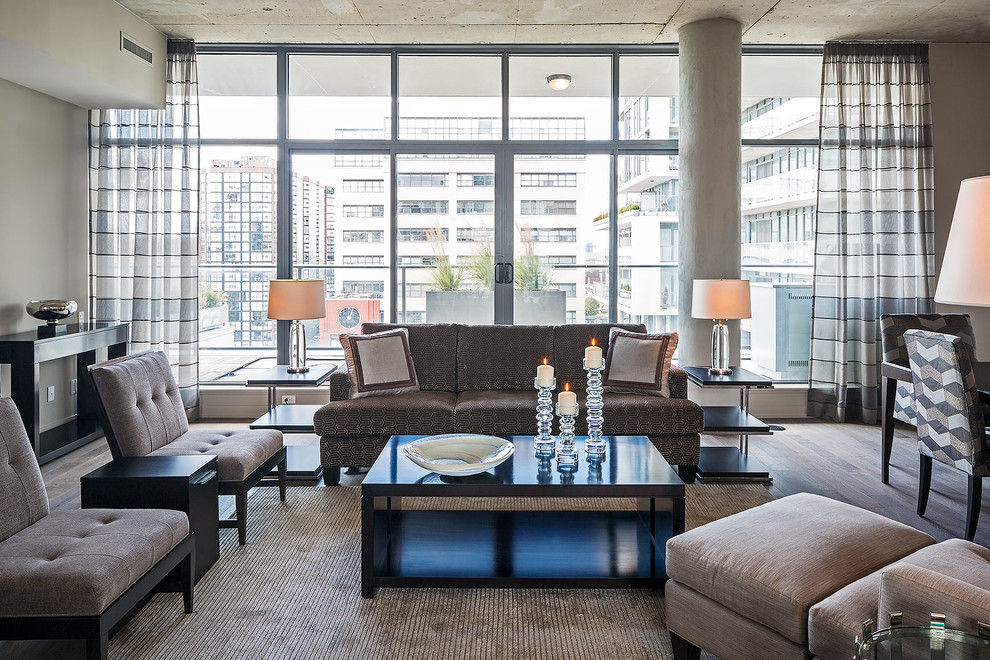 Contemporary open plan living room in Toronto with grey walls and dark hardwood flooring.
