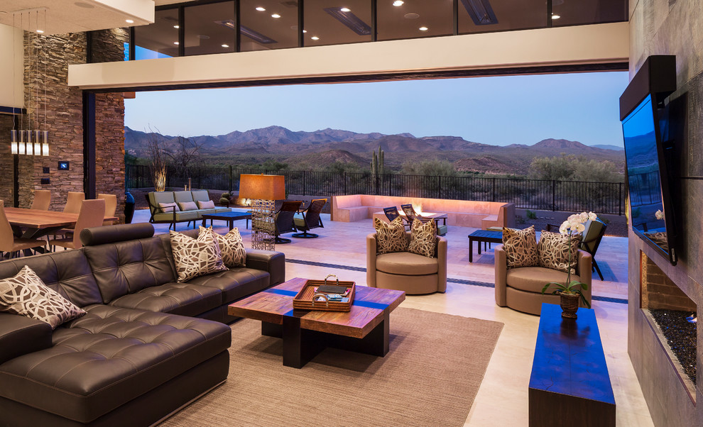This is an example of a contemporary open plan living room in Phoenix with a ribbon fireplace and a wall mounted tv.