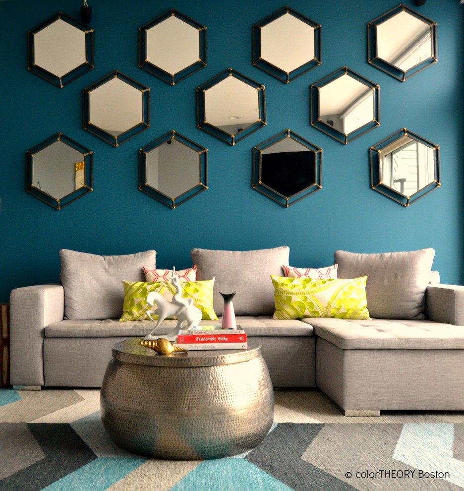 Ejemplo de salón tipo loft bohemio grande con paredes azules, suelo de madera en tonos medios, todas las chimeneas, marco de chimenea de madera y televisor colgado en la pared