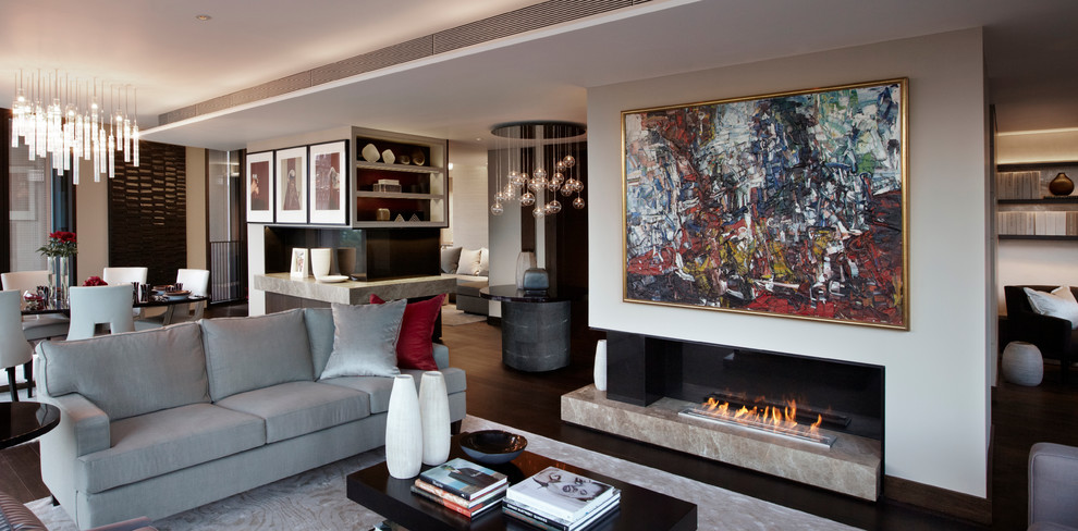 Photo of a contemporary formal open plan living room in London with beige walls, dark hardwood flooring and a ribbon fireplace.