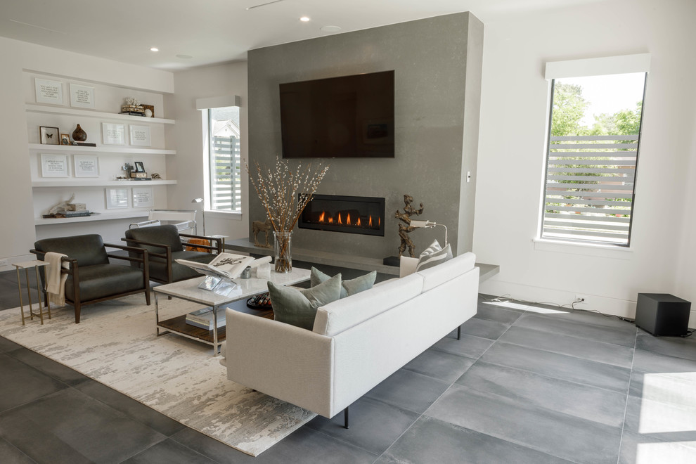 Inspiration for a medium sized contemporary formal open plan living room in Houston with white walls, porcelain flooring, a standard fireplace, a stone fireplace surround, a wall mounted tv and grey floors.