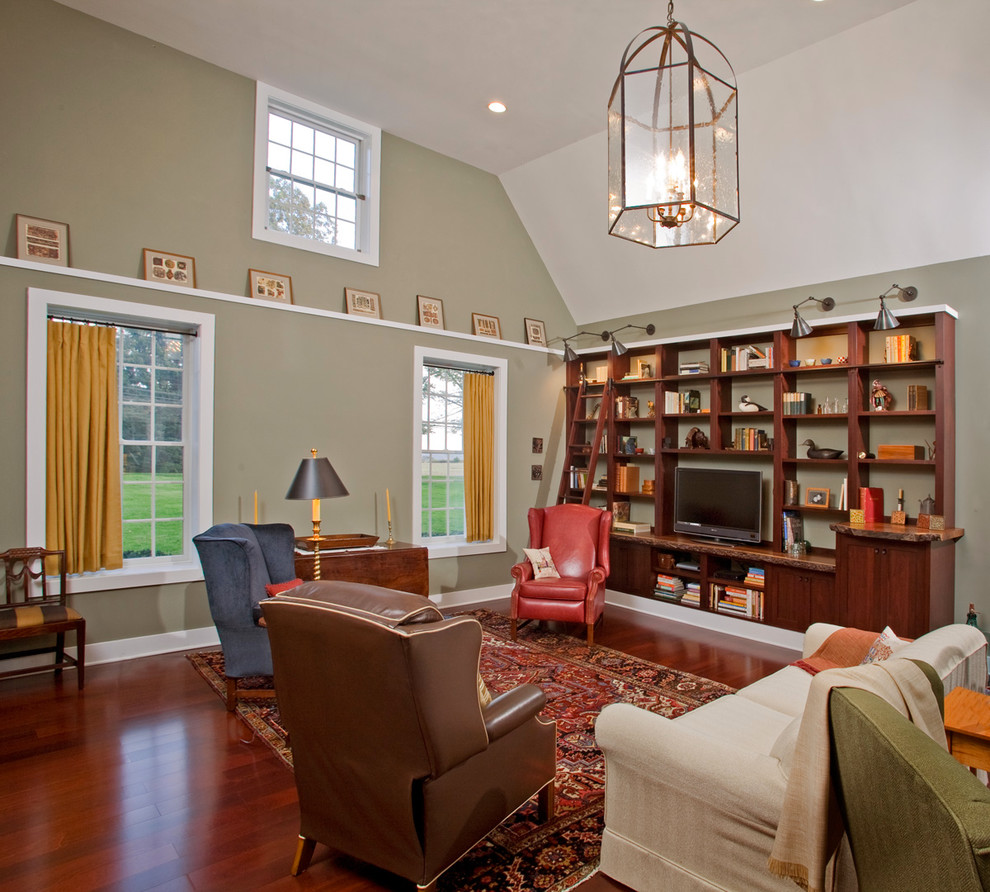 This is an example of a traditional living room in Philadelphia with beige walls and a freestanding tv.
