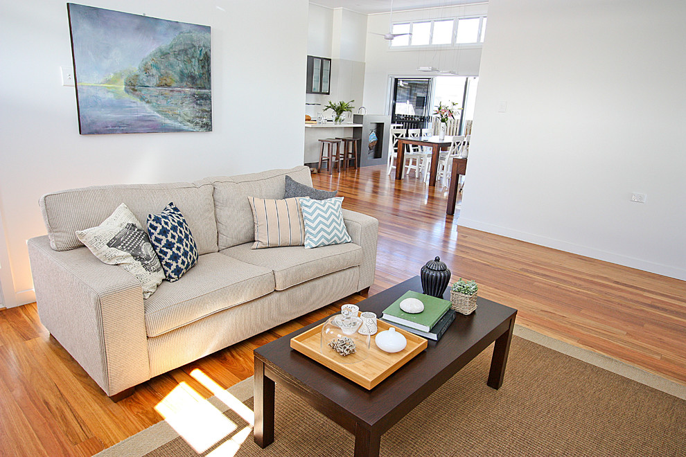 Photo of a beach style living room in Brisbane with white walls.