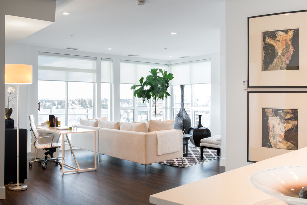 Inspiration for a small contemporary open concept dark wood floor living room remodel in Calgary with white walls and a wall-mounted tv