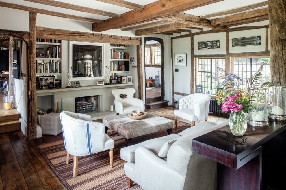 Inspiration for a medium sized rustic enclosed living room in London with white walls, dark hardwood flooring, brown floors, a standard fireplace and a stone fireplace surround.