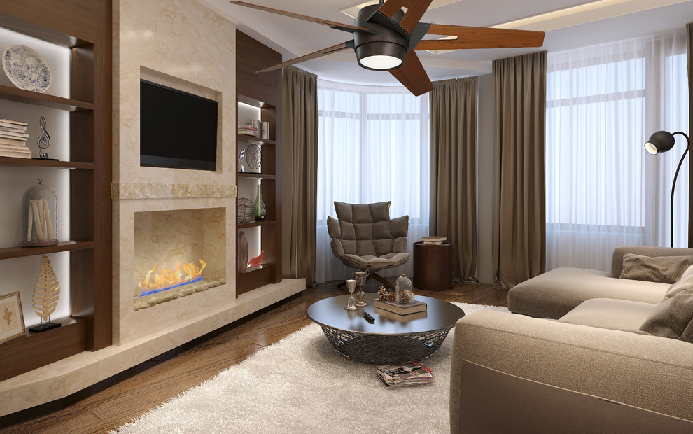 Cette photo montre un salon tendance de taille moyenne et fermé avec un mur beige, un sol en bois brun, une cheminée standard, un manteau de cheminée en pierre et un téléviseur encastré.