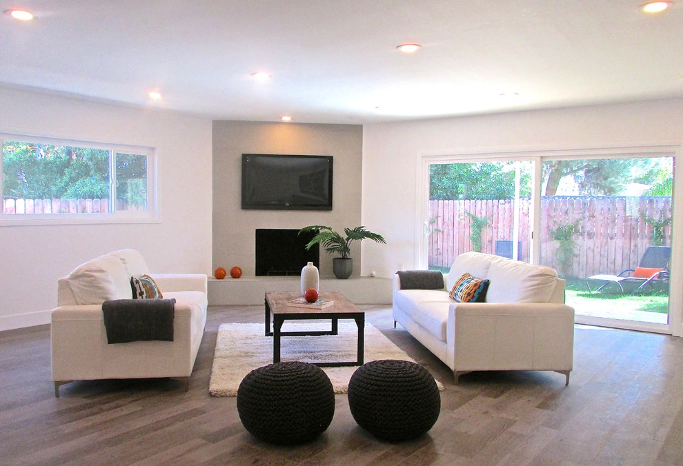 Large contemporary open plan living room in Los Angeles with beige walls and medium hardwood flooring.