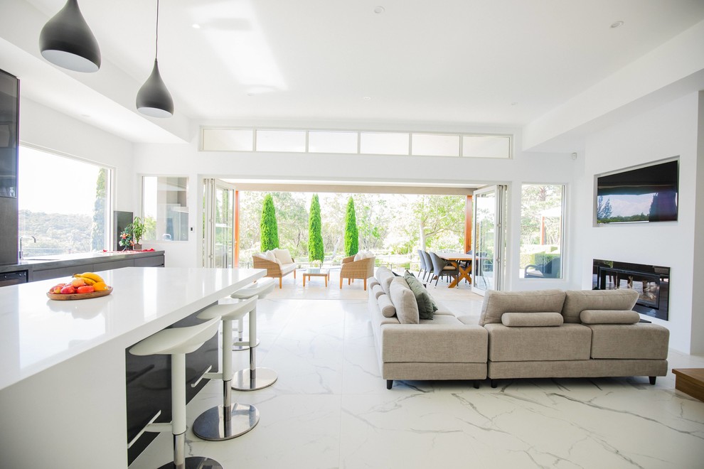 Design ideas for a large contemporary open plan living room in Sydney with white walls, marble flooring and a wall mounted tv.