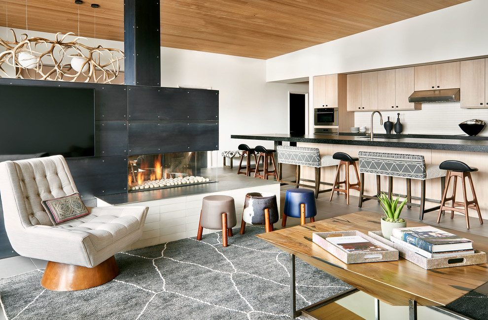 Trendy open concept gray floor living room photo in Denver with white walls, a two-sided fireplace, a metal fireplace and a wall-mounted tv