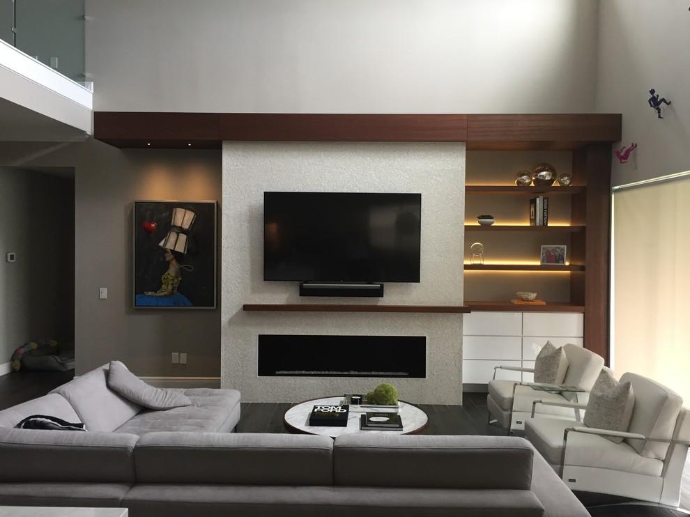 This is an example of an expansive contemporary living room in Orlando with a ribbon fireplace, a tiled fireplace surround, a wall mounted tv and black floors.