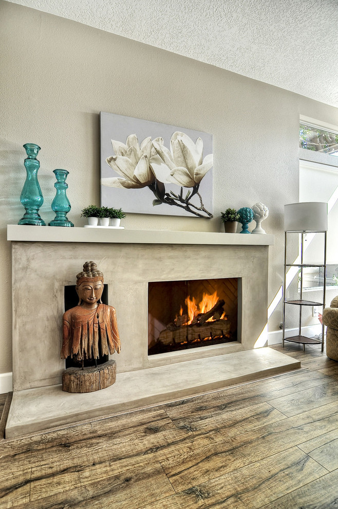 Inspiration for a large contemporary open plan living room in Orange County with beige walls, a standard fireplace, a plastered fireplace surround and a wall mounted tv.