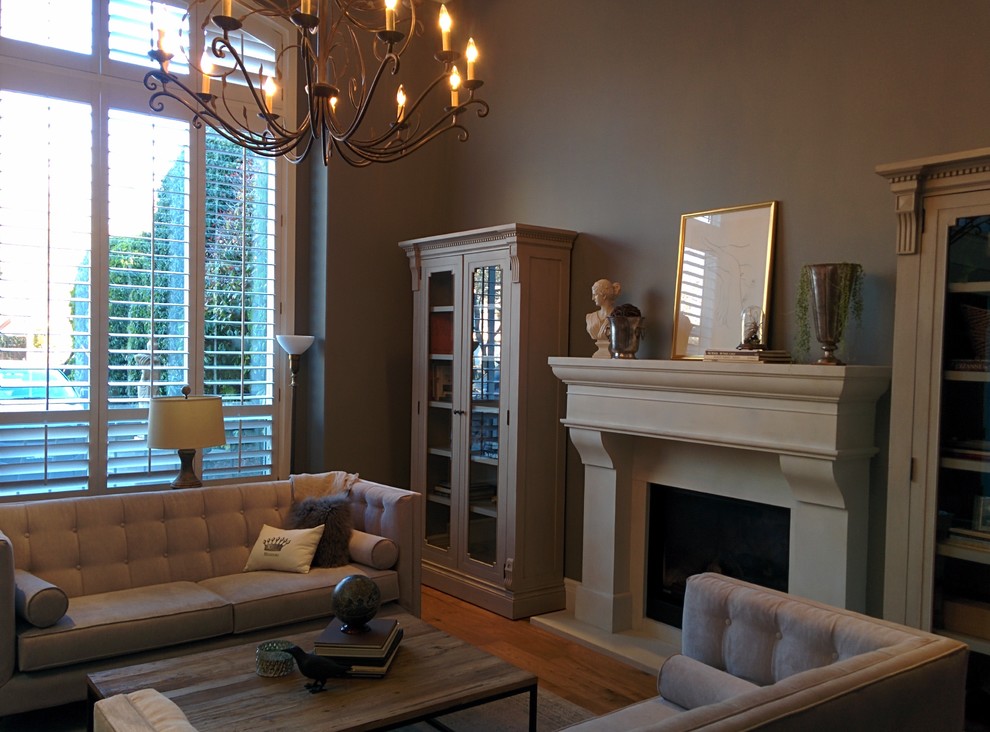 This is an example of a medium sized contemporary formal enclosed living room in Vancouver with white walls, dark hardwood flooring, a standard fireplace, a concrete fireplace surround, no tv and brown floors.