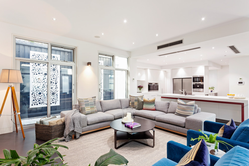 Idee per un soggiorno design aperto con pareti bianche, parquet scuro e pavimento marrone