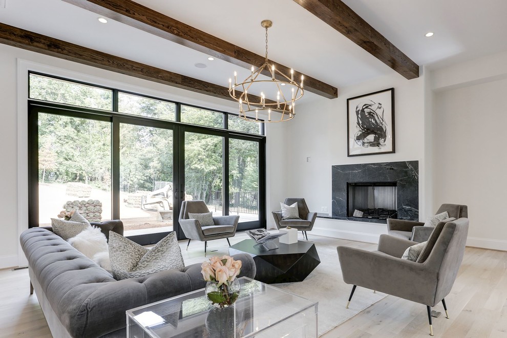 Inspiration for a contemporary living room in DC Metro with white walls, light hardwood flooring, a standard fireplace, a stone fireplace surround, no tv and beige floors.