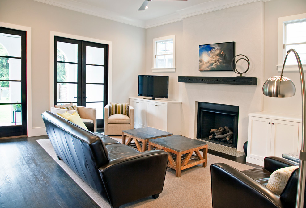 На фото: гостиная комната в современном стиле с бежевыми стенами, темным паркетным полом, стандартным камином и отдельно стоящим телевизором
