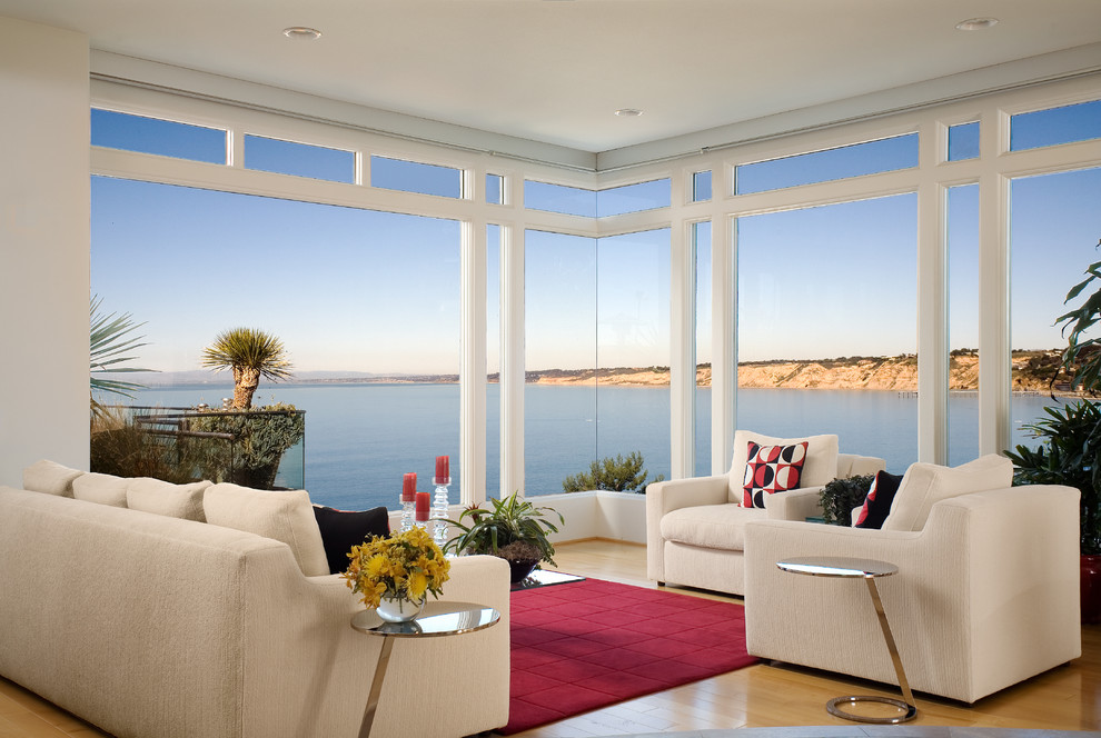 Inspiration for a contemporary open plan living room in San Diego with white walls and medium hardwood flooring.