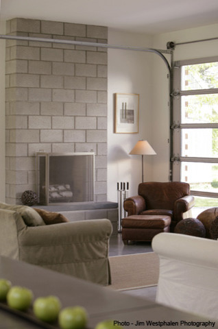 Photo of a large contemporary formal open plan living room in Burlington with white walls, a standard fireplace and a brick fireplace surround.