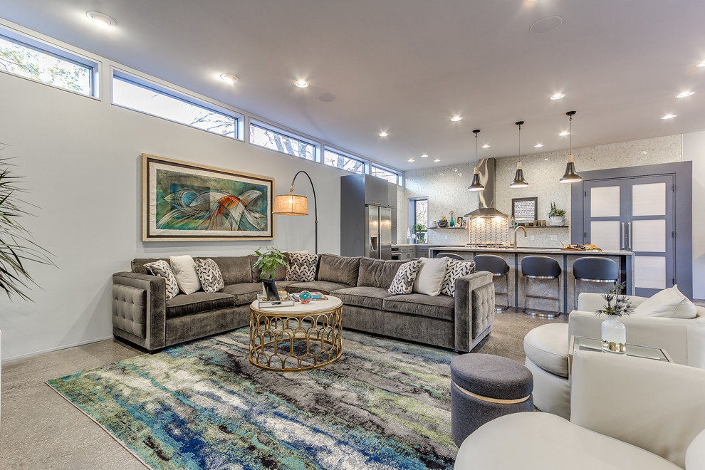 Photo of a medium sized contemporary open plan living room in Oklahoma City with white walls, concrete flooring, grey floors and feature lighting.