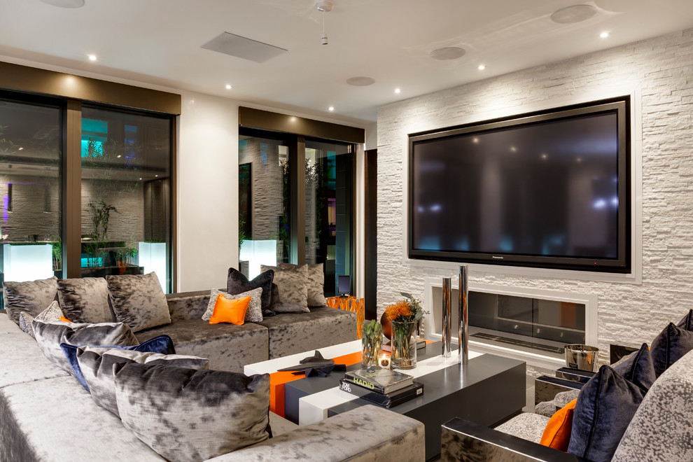 Свежая идея для дизайна: гостиная комната в современном стиле с горизонтальным камином, телевизором на стене и бежевыми стенами - отличное фото интерьера