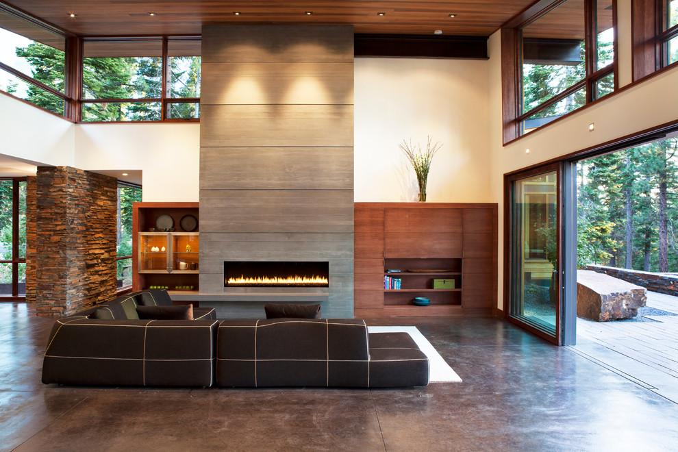 Cette image montre un salon design avec sol en béton ciré.