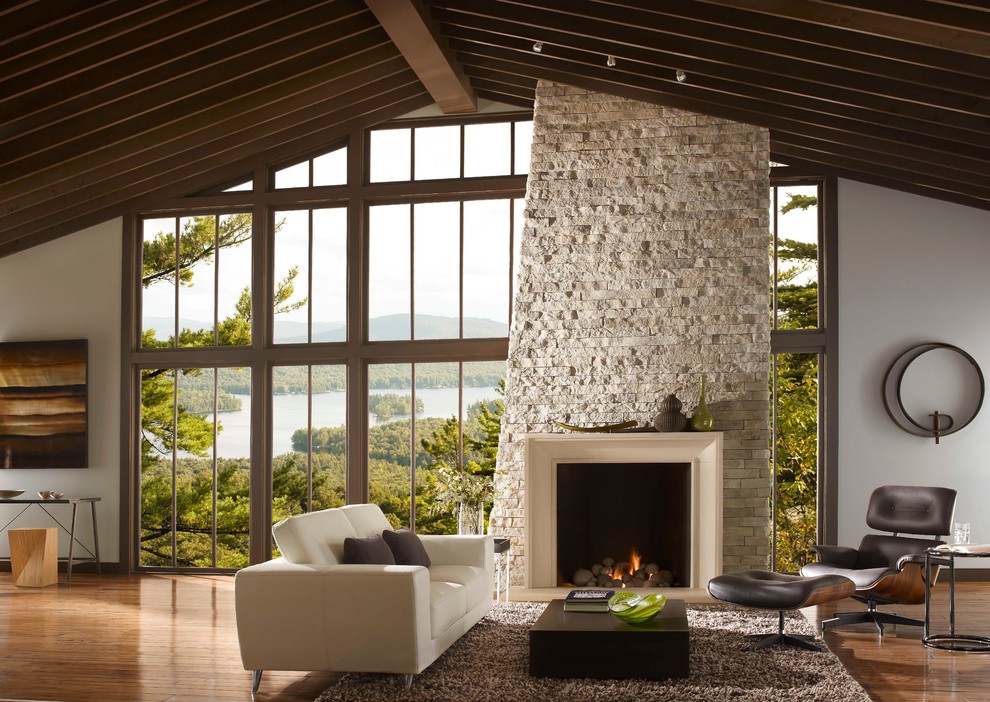 Example of a trendy open concept living room design with a stone fireplace and no tv