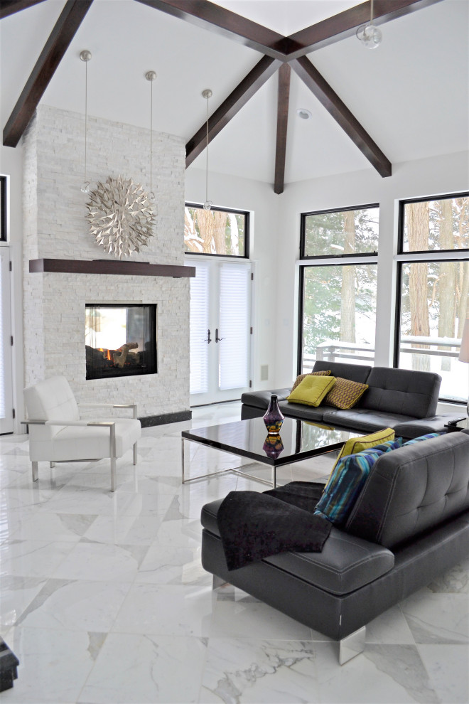This is an example of a medium sized contemporary formal open plan living room with white walls, a two-sided fireplace, a stone fireplace surround, no tv, marble flooring and feature lighting.