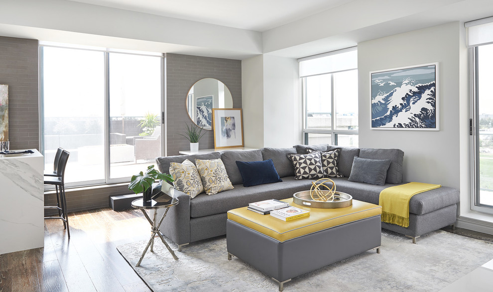 Photo of a contemporary living room in Toronto with white walls, dark hardwood flooring and brown floors.