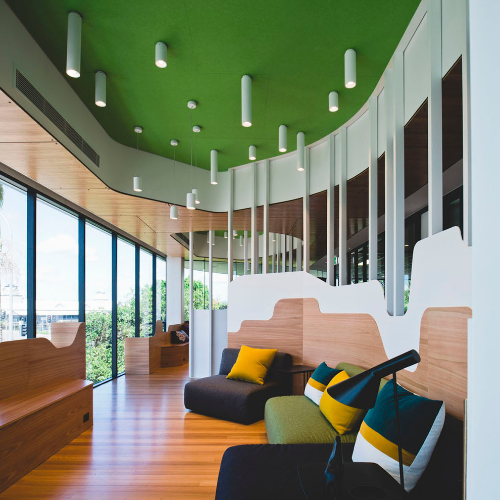 Contemporary living room in Brisbane with light hardwood flooring.