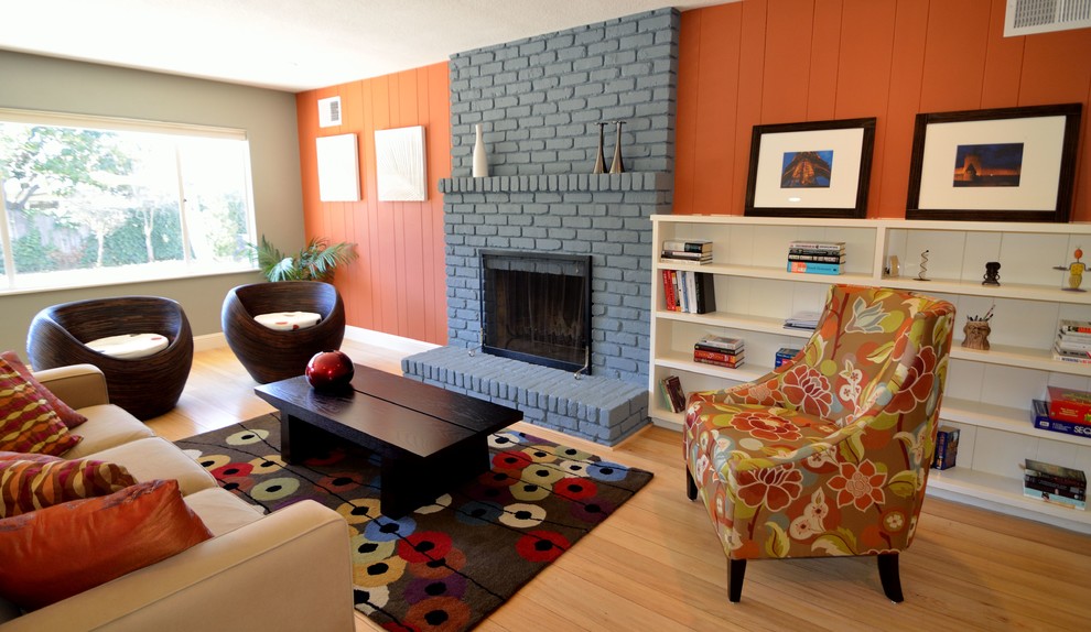 Example of a trendy living room design in Other with a standard fireplace and a brick fireplace