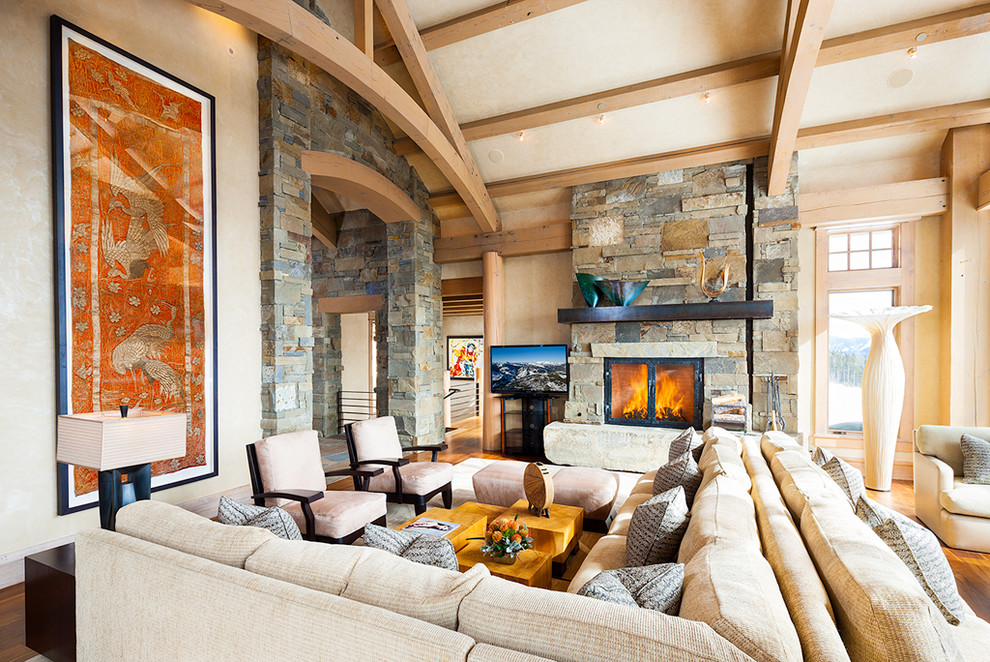 Photo of a contemporary living room in Other with a stone fireplace surround.