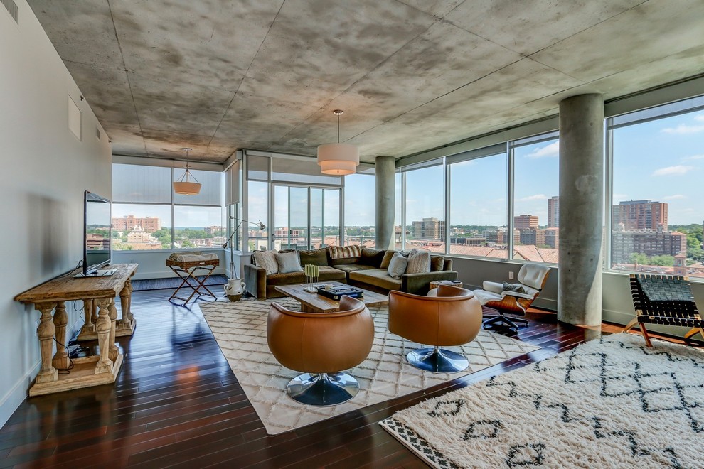 Large contemporary formal open plan living room in Kansas City with white walls, dark hardwood flooring and a freestanding tv.