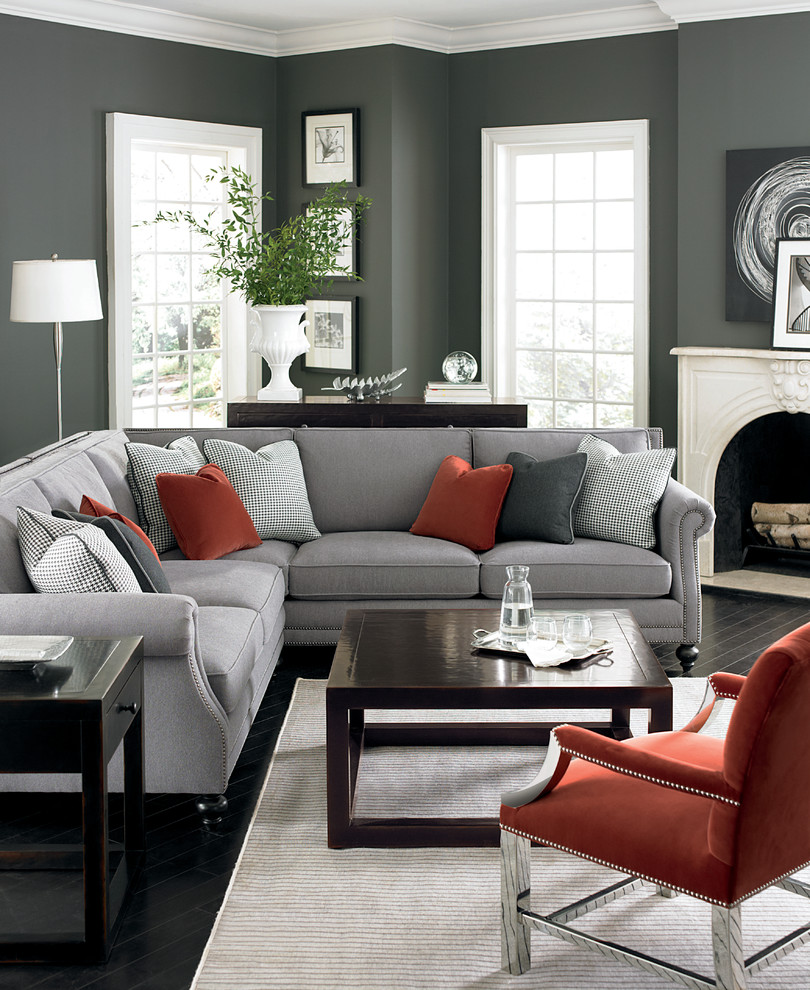 Example of a mid-sized trendy formal and open concept painted wood floor and black floor living room design in New York with gray walls, a standard fireplace, a plaster fireplace and no tv