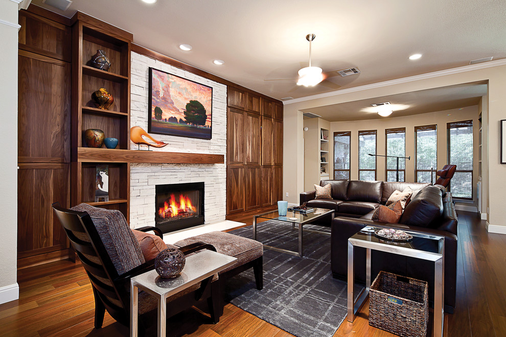 Photo of a contemporary living room in Austin with a stone fireplace surround.