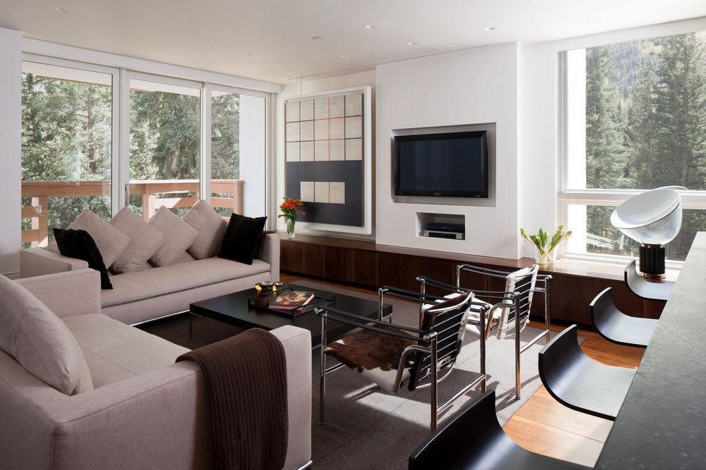 Example of a trendy living room design in Denver with a concealed tv