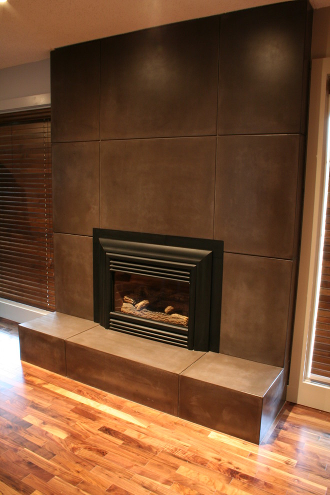 Trendy living room photo in Calgary with a standard fireplace and a concrete fireplace